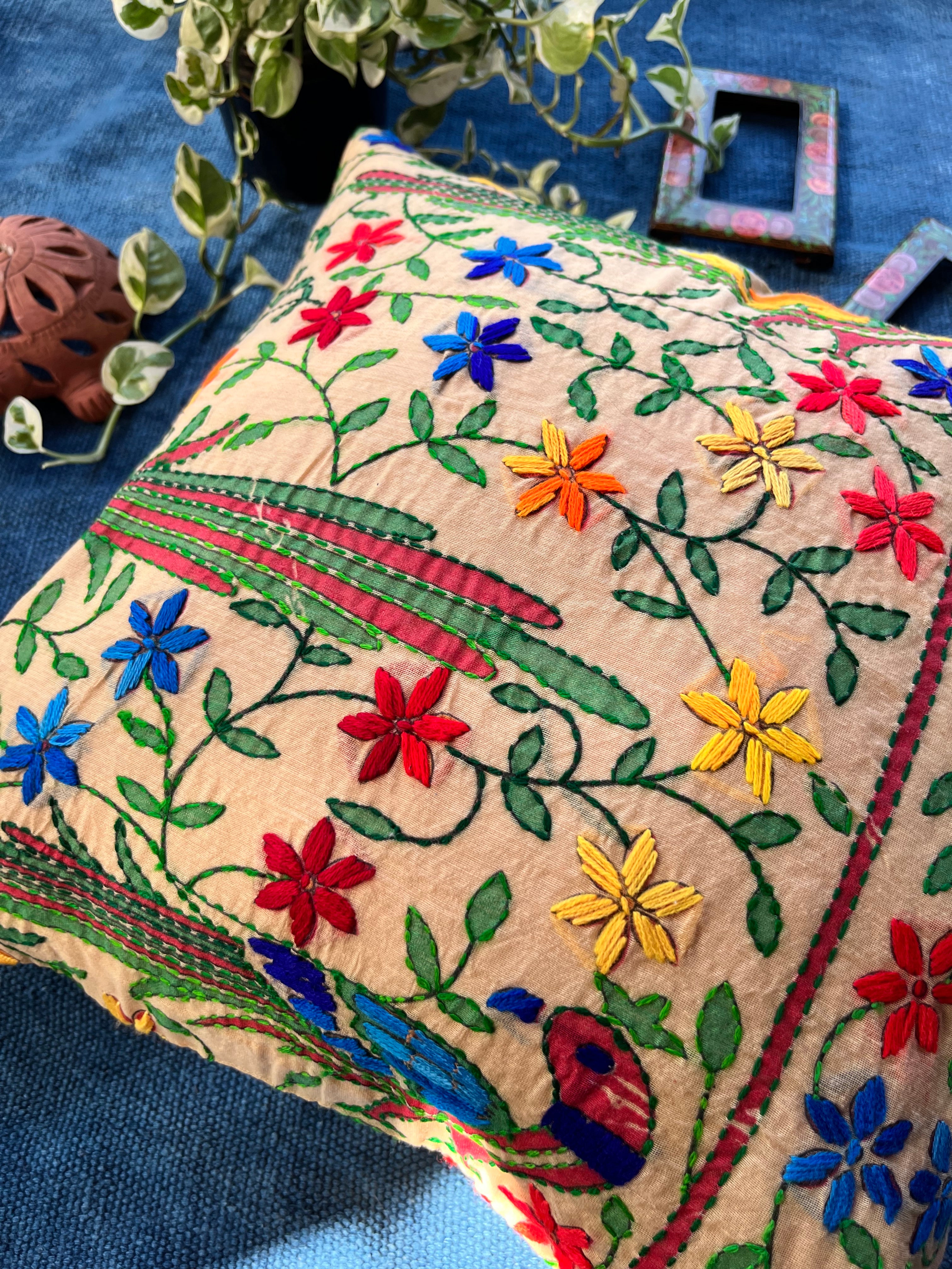 "16x16 inch cushion cover featuring vibrant block printed patterns and intricate hand embroidery, adding a touch of artisanal charm to any space."