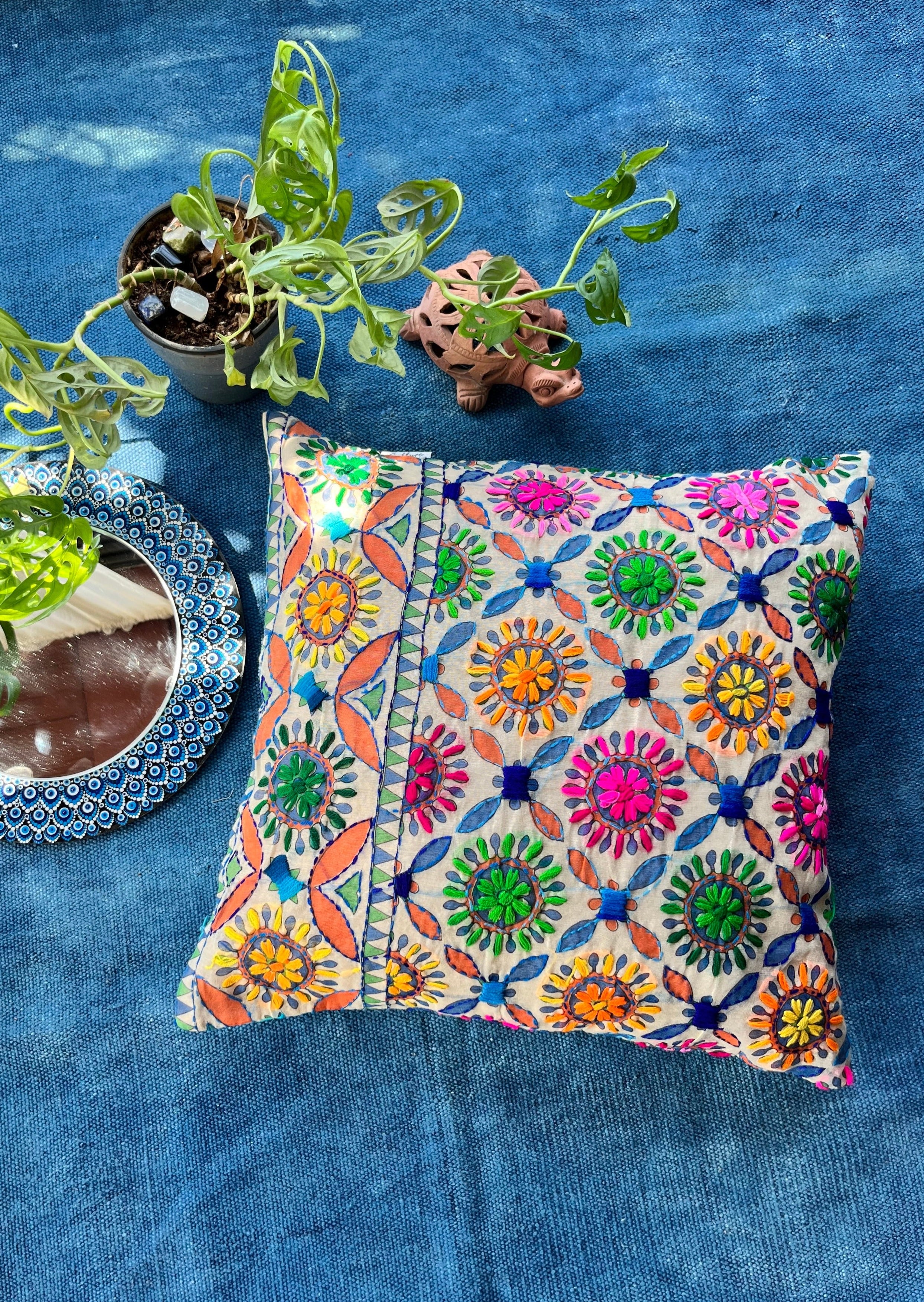 "Block printed and hand embroidered cushion cover in 18x18 size featuring intricate floral designs and vibrant colors, perfect for adding a touch of artistry to your home decor."