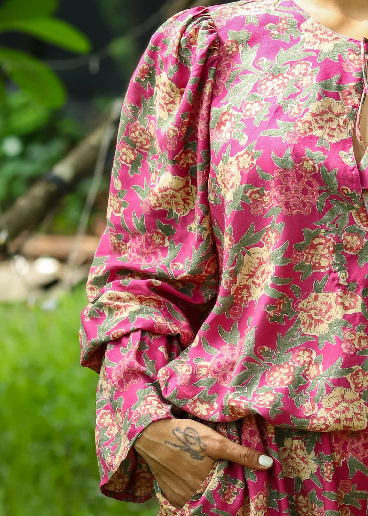 Model wearing a Faye Handblock Printed Playsuit with vibrant floral patterns, featuring a relaxed fit and short sleeves, perfect for casual summer outings.