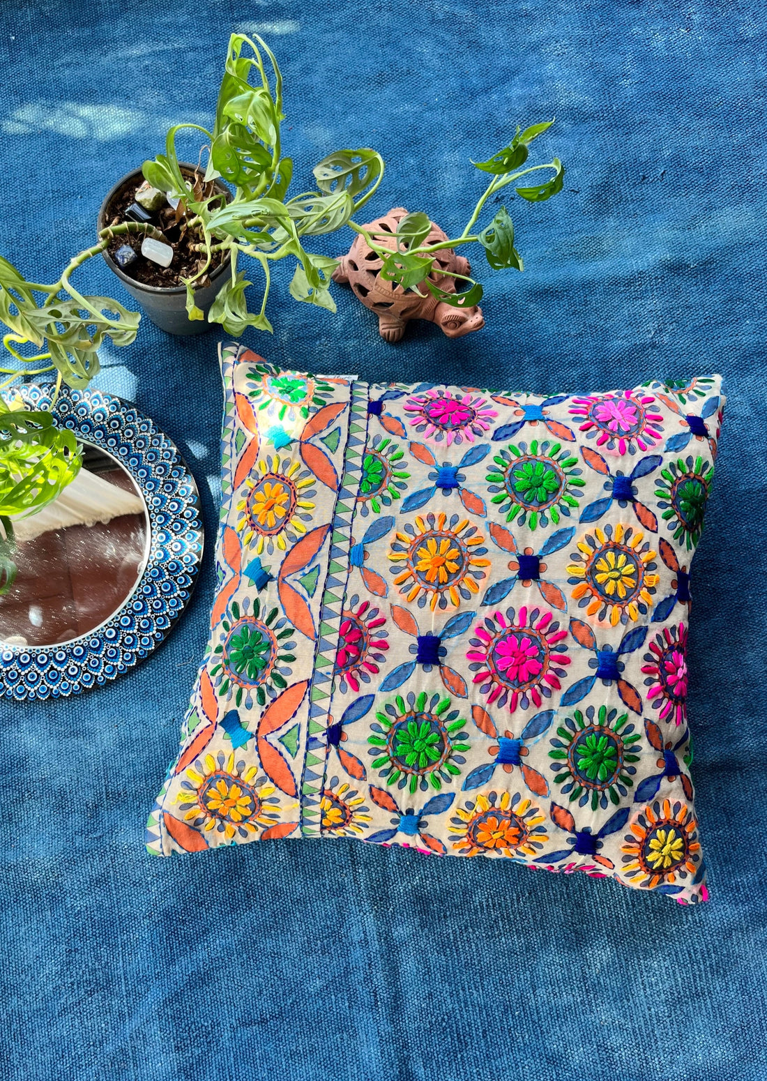 "Block printed and hand embroidered cushion cover in 18x18 size featuring intricate floral designs and vibrant colors, perfect for adding a touch of artistry to your home decor."